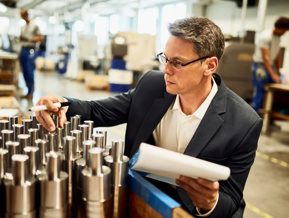 quality-control-inspector-examining-manufactured-steel-cylinders-factory quality-control-inspector-examining-manufactured-steel-cylinders-factory